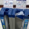 Mechanical umbrella-bagging machine at a building entrance in Japan.